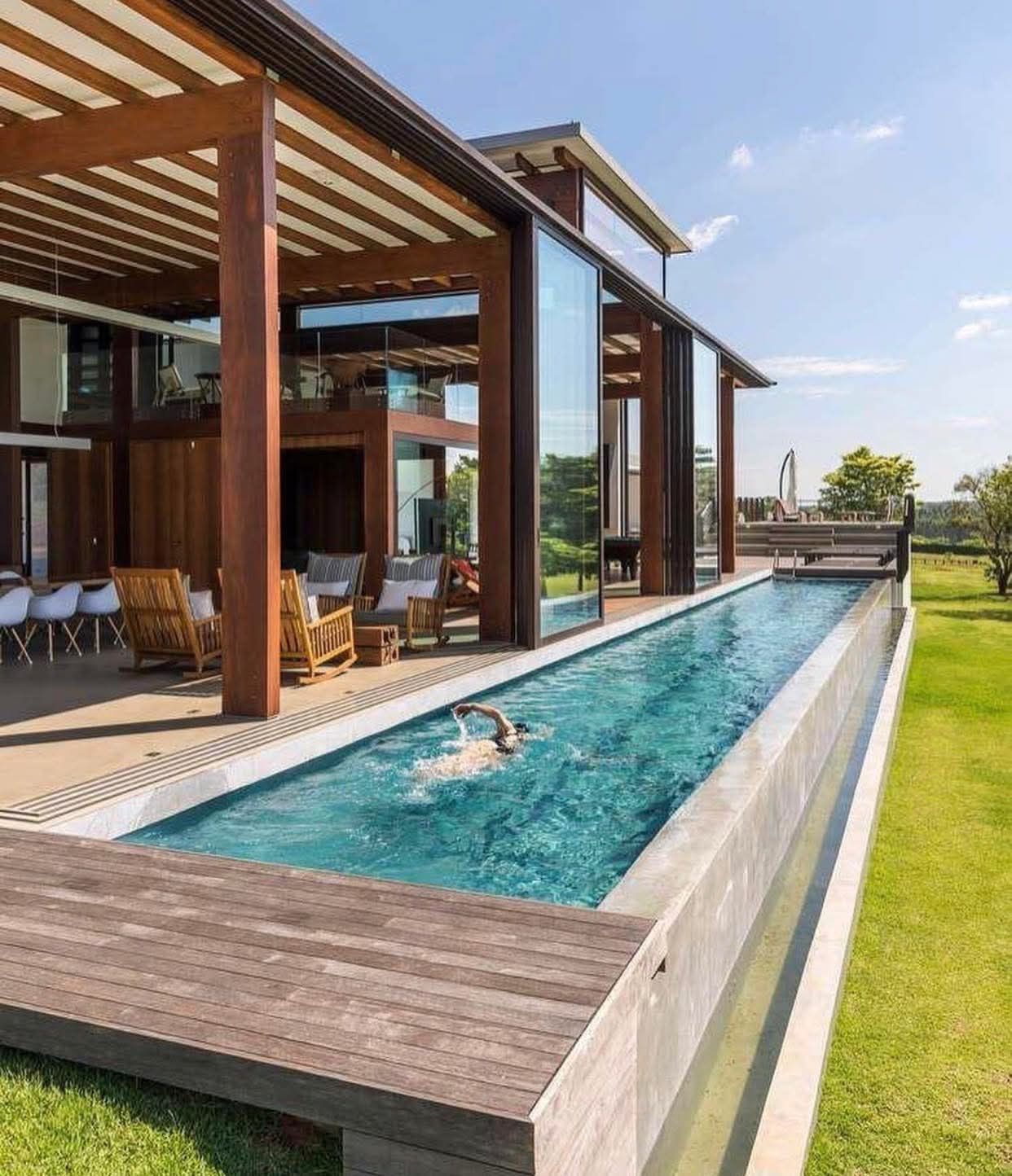 Villa With a Long Narrow Pool, Wooden Deck, and Glass Walls — RYDALL BUILDING AND DEVELOPMENT in Freshwater, QLD