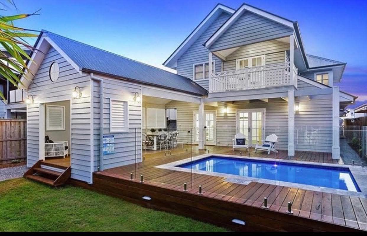 Two-story Gray House With a Wooden Deck and Blue Pool — RYDALL BUILDING AND DEVELOPMENT in Freshwater, QLD