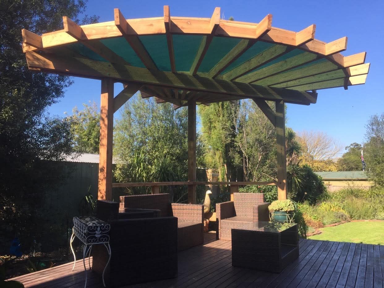 Patio Pergola With Wooden Roof and Wicker Seating — RYDALL BUILDING AND DEVELOPMENT in Freshwater, QLD