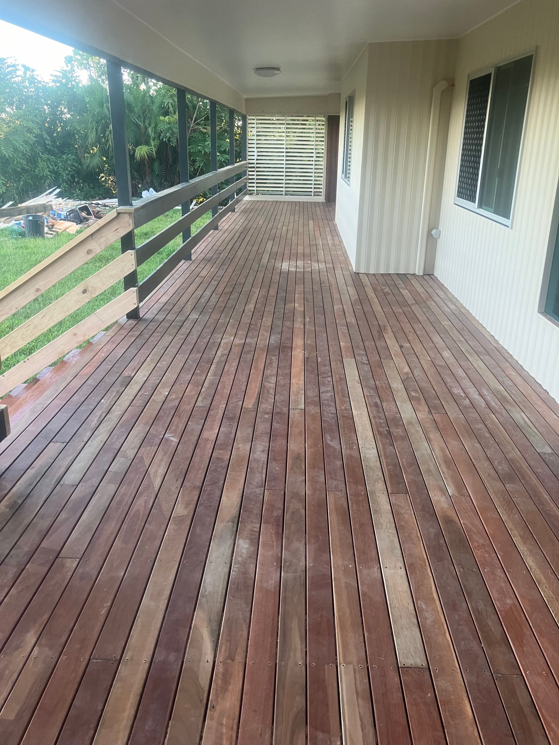 Wooden Deck Walkway Beside a House, With White Railing — RYDALL BUILDING AND DEVELOPMENT in Freshwater, QLD.