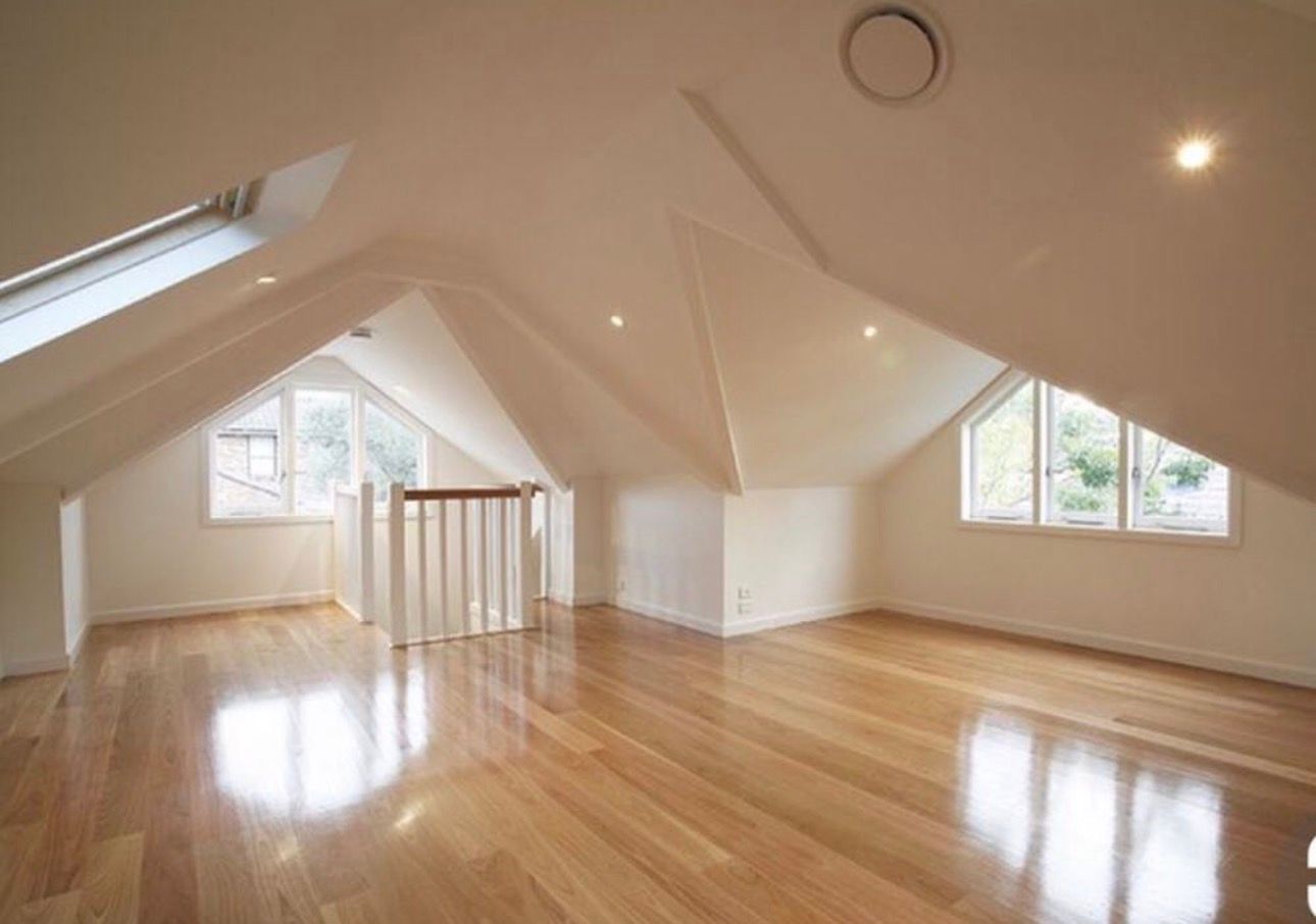 Bright Empty Attic Room With Polished Wood Floors — RYDALL BUILDING AND DEVELOPMENT in Freshwater, QLD