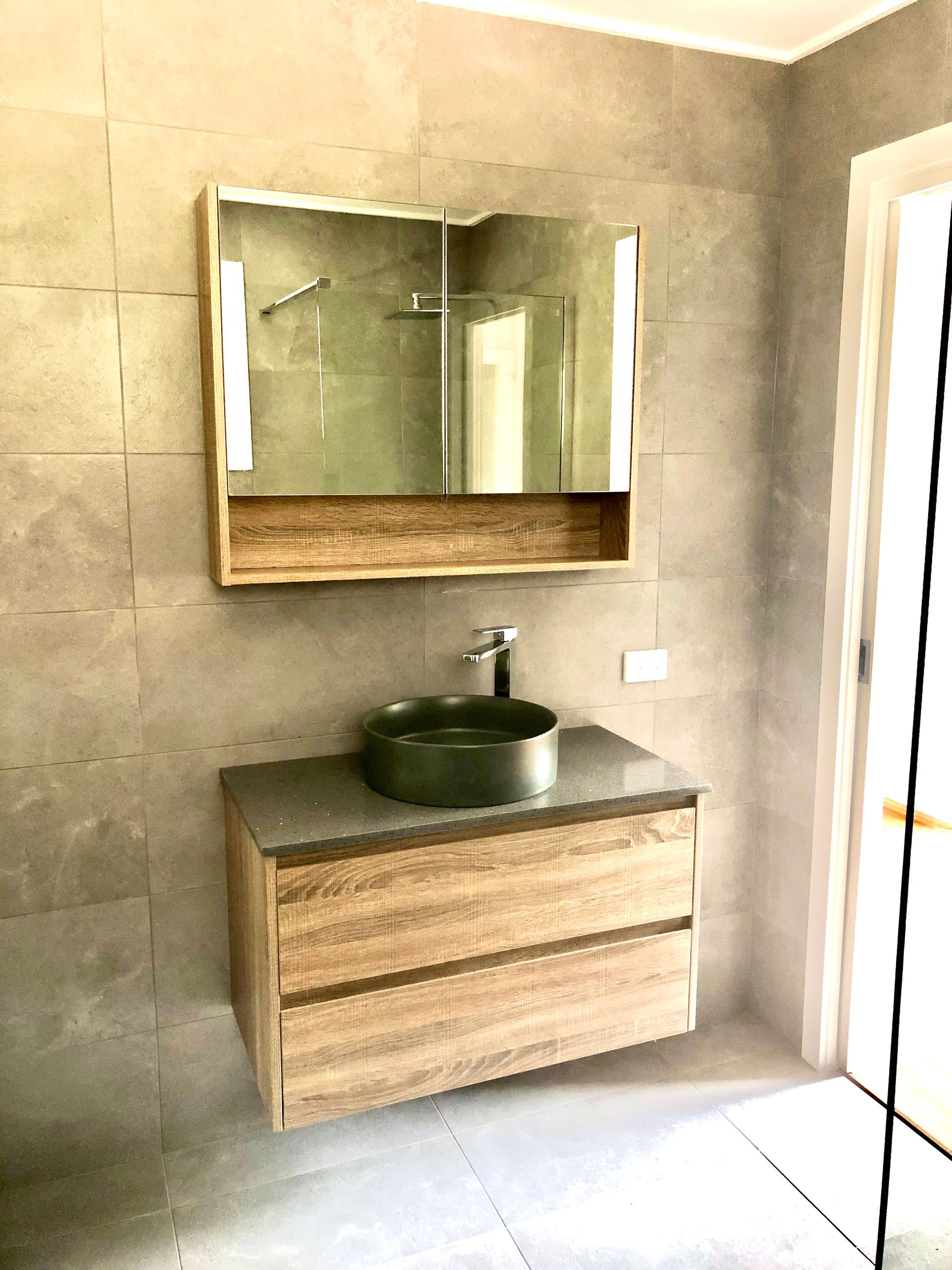 Modern Bathroom With Wood Vanity, Round Black Sink — RYDALL BUILDING AND DEVELOPMENT in Freshwater, QLD