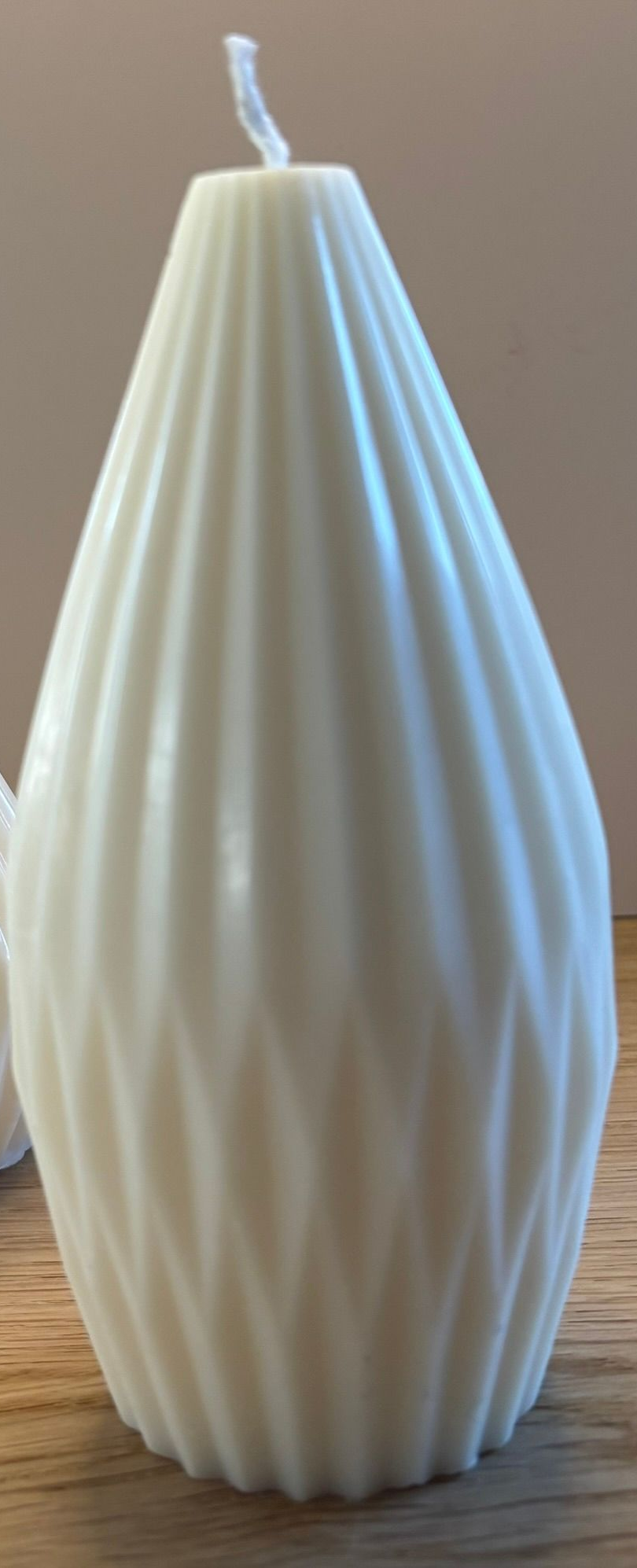Twee handgemaakte Cone Pillar kaarsen van sojawas in ivoorwit, verkrijgbaar in Small en Large, met een elegant geribbeld design.
