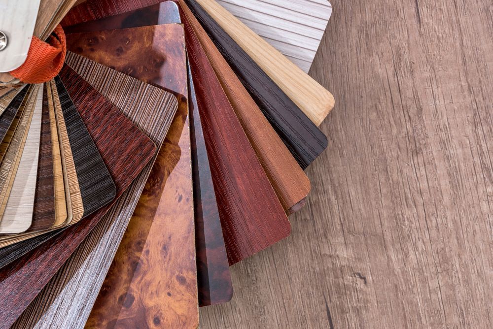 A Fan of Different Types of Wood Samples on a Wooden Table — Taggerts Discount Carpets & Vinyls In California Gully, VIC