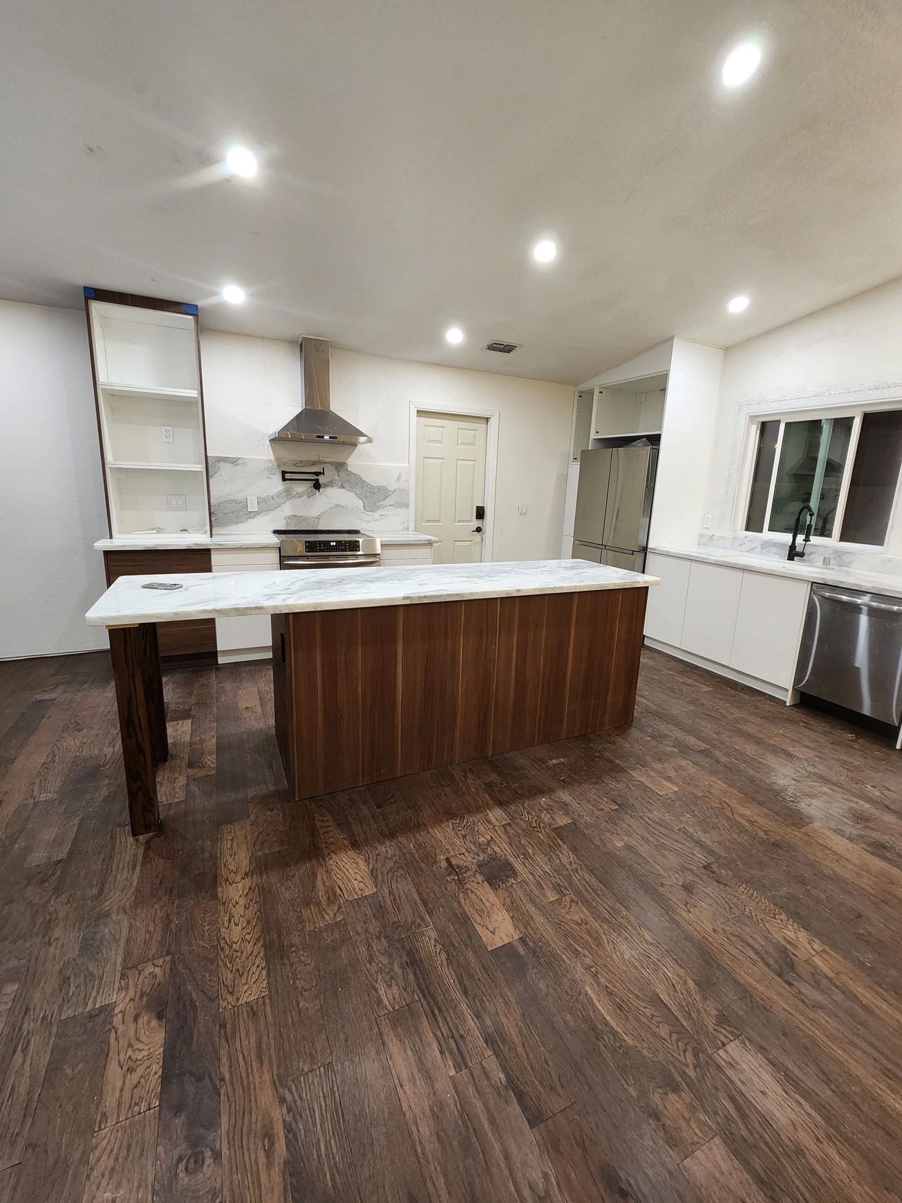 A kitchen with a large island in the middle of the room.