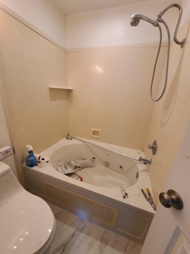 A bathroom with a jacuzzi tub and a toilet.