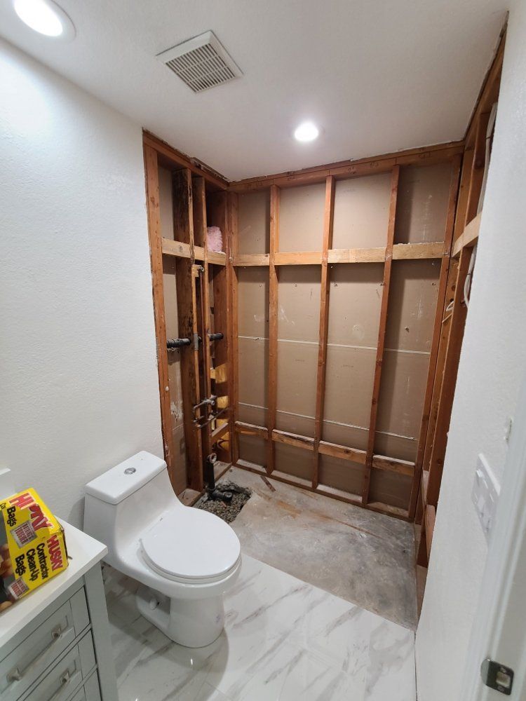 A bathroom with a toilet and a sink under construction.