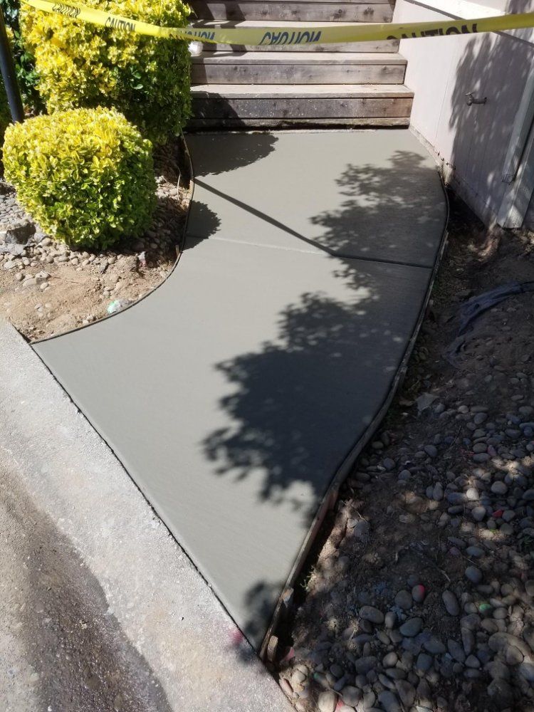 A concrete walkway is being built next to a set of stairs.