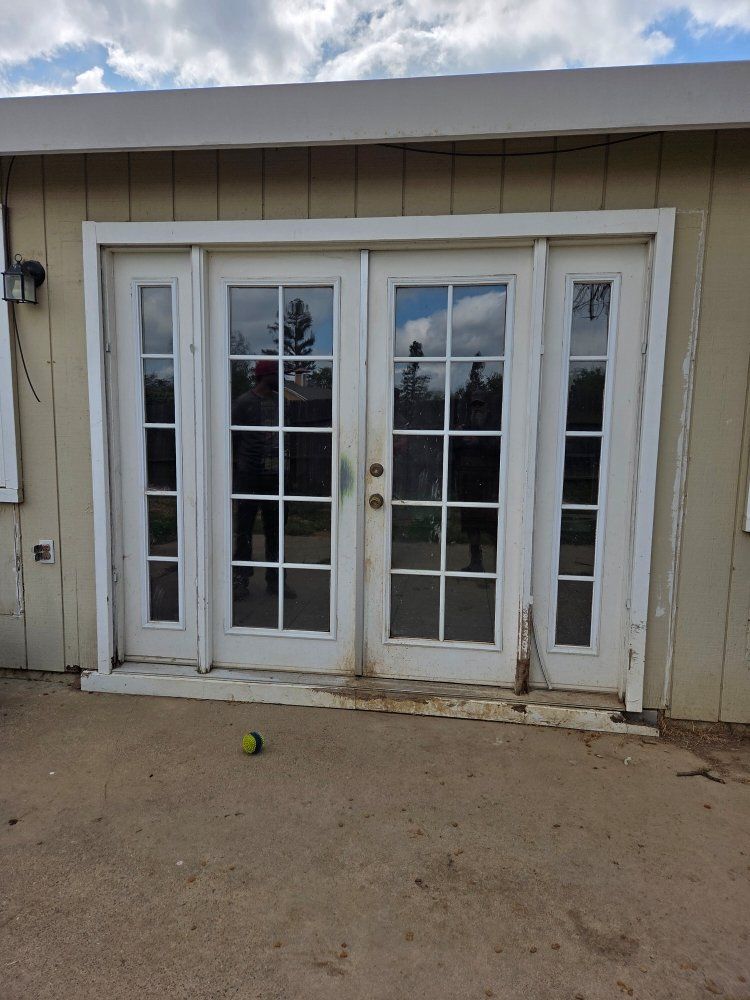 A house with a lot of windows and a tennis ball on the ground