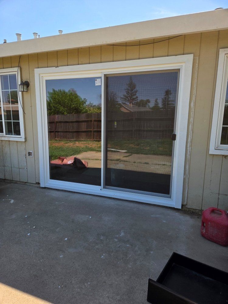 A sliding glass door on the side of a house