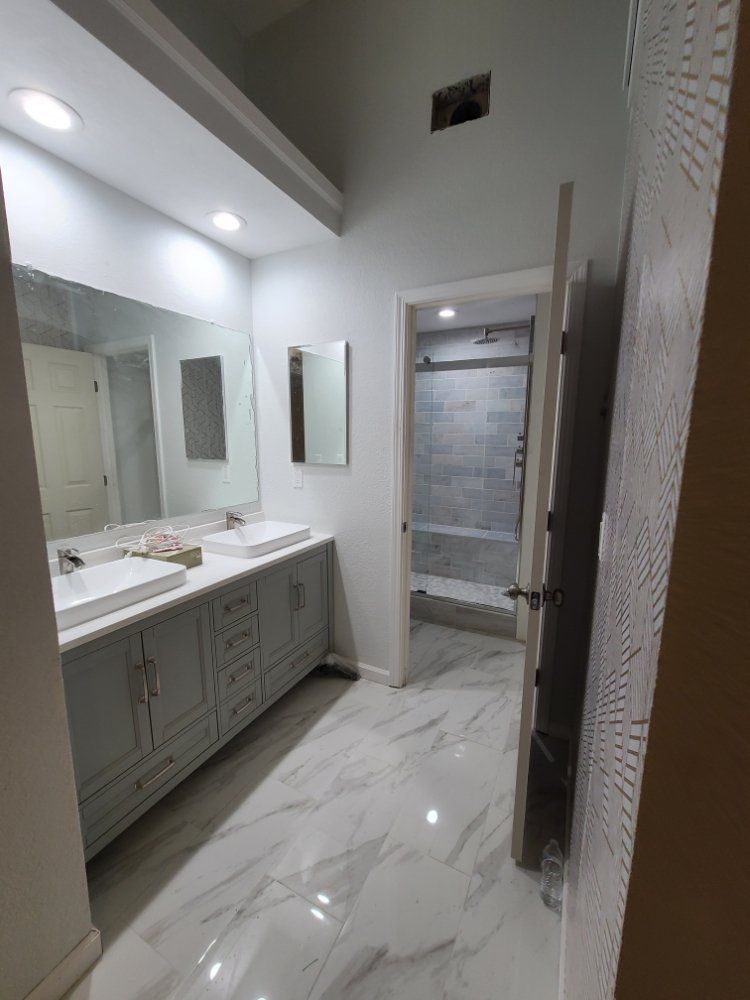 A bathroom with two sinks and a mirror
