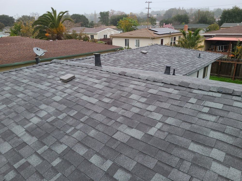 The roof of a house with a satellite dish on it.
