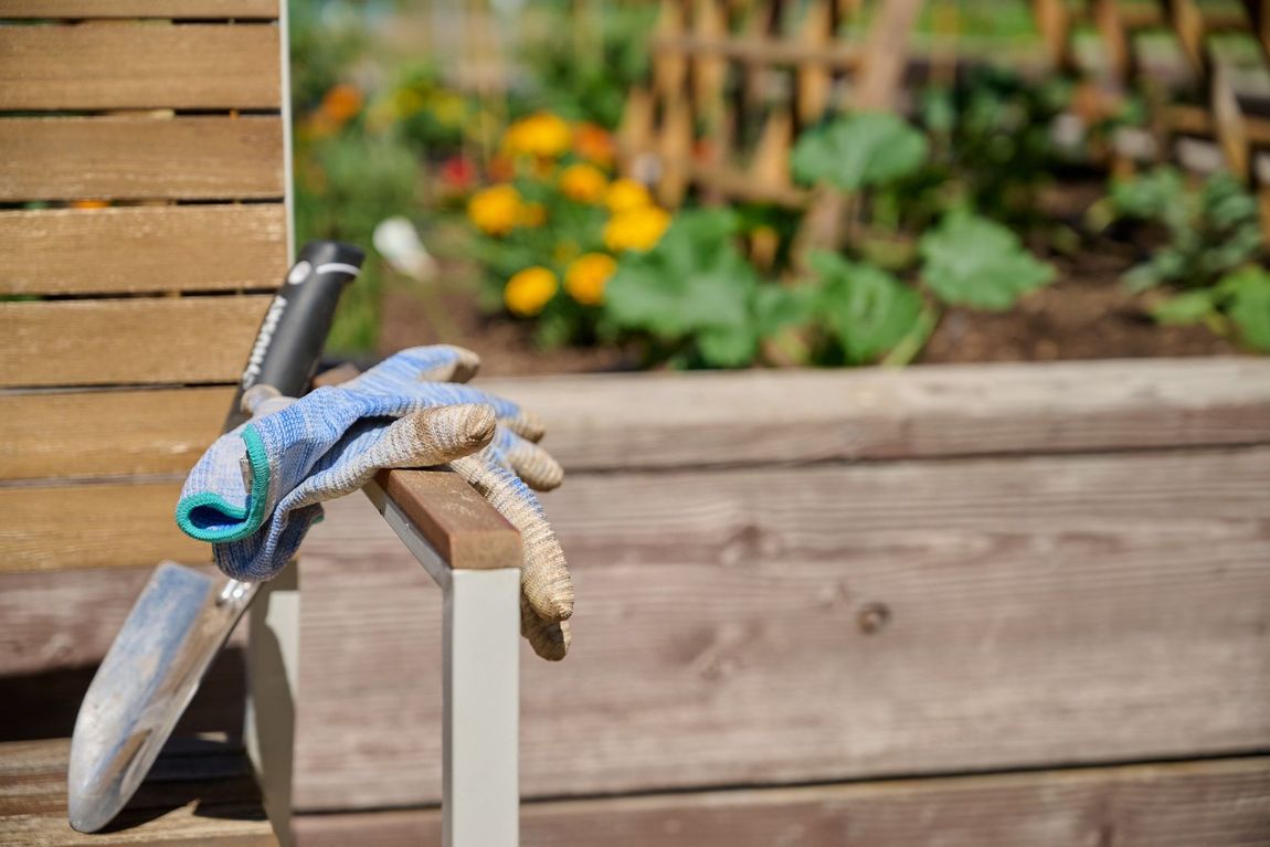 Gardening gloves and trowel on a wooden bench — boise apartments for rent