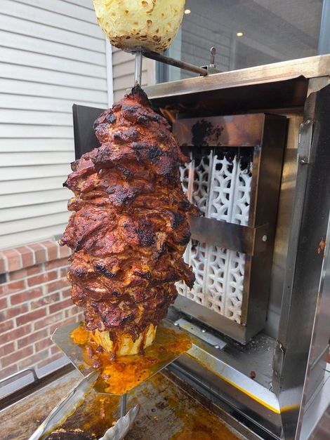 Large vertical rotisserie of seasoned meat — Apartments for Rent Boise
