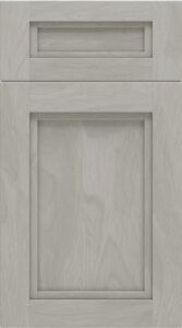 Two light wood cabinet doors, one narrow drawer above a larger panel door.