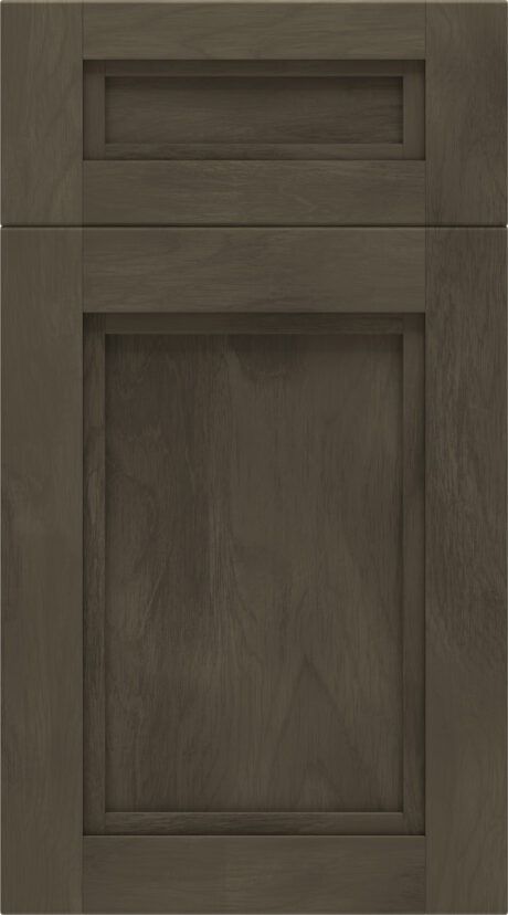 Dark wood cabinet door with a small upper drawer and raised panel design