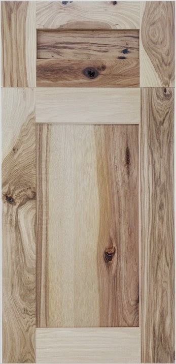 Close-up of a light wood door panel with natural grain and darker knots.