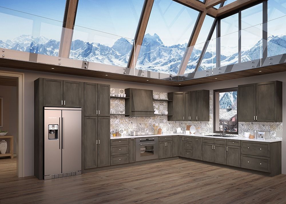Modern kitchen with gray cabinets, stainless fridge, wood floors, and large windows overlooking snowy mountains