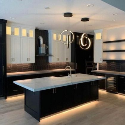 Modern black-and-white kitchen with a large island and pendant lights