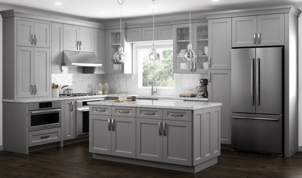 Bright modern kitchen with gray cabinets, stainless steel appliances, and a central island by a window