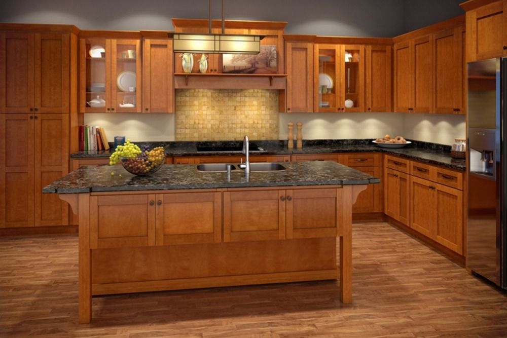 Spacious modern kitchen with warm wood cabinets, granite island, and stainless steel appliances.