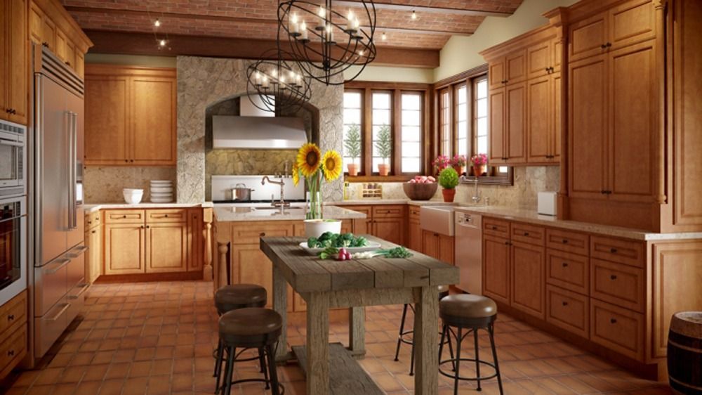 Warm rustic kitchen with wood cabinets, island table, stools, and sunlight through windows.