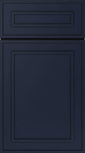 Dark navy cabinet front with a small drawer above a larger panel door.