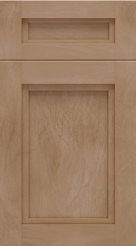 Light wood cabinet door with a narrow drawer above it