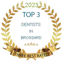 A gold laurel wreath with the words `` top 3 dentists in brossard '' written on it.
