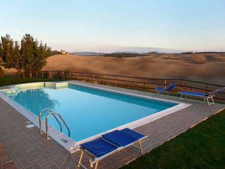 a swimming pool with concrete walkway