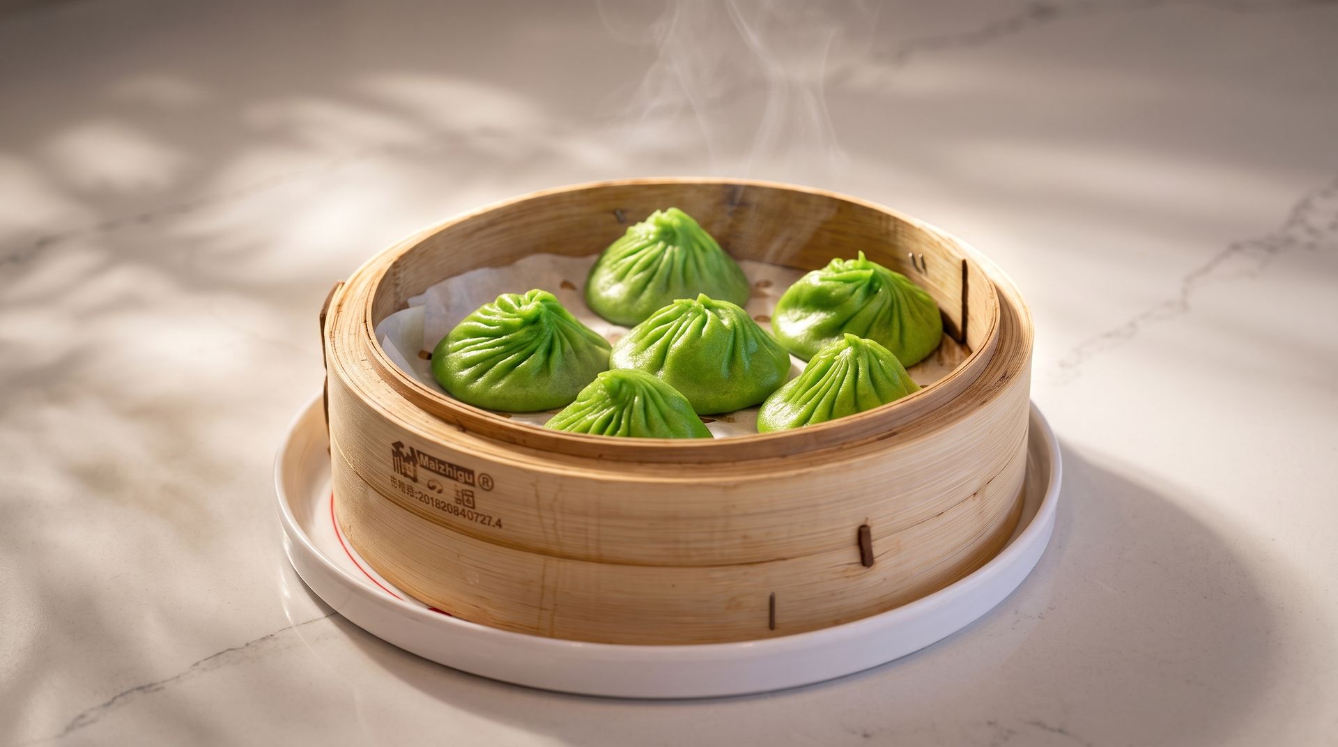 Steamed green dumplings in a bamboo basket on a white plate, lit by soft sunlight.