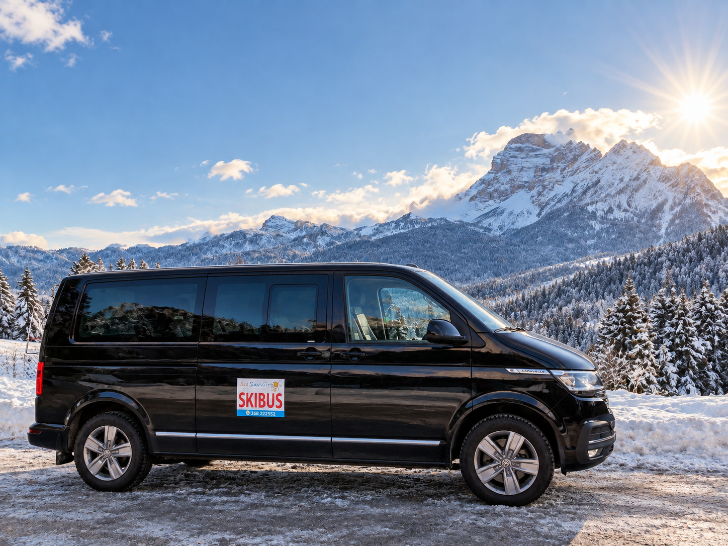 Black passenger van parked in snowy mountains under bright sun