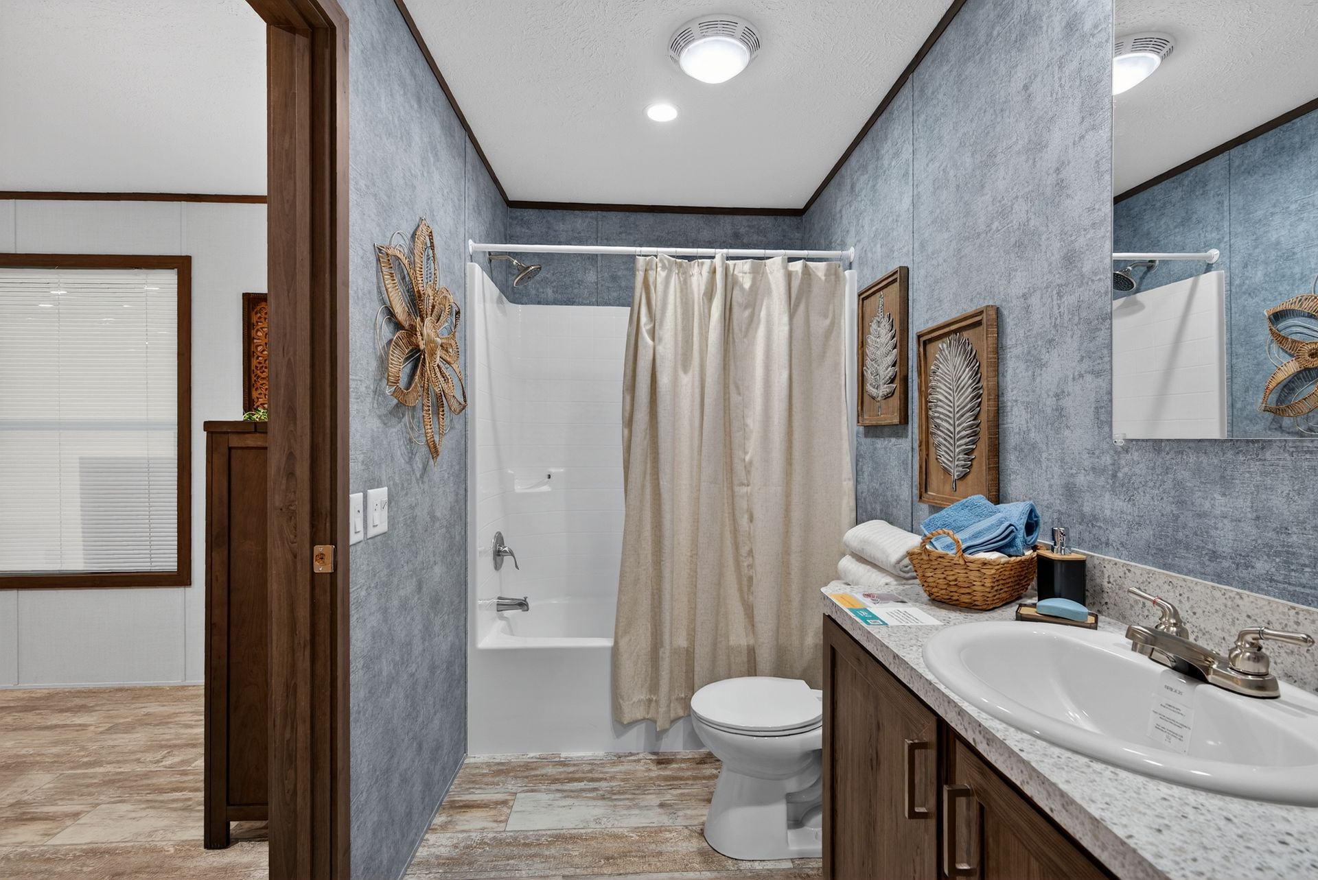 Modern bathroom with a shower, white vanity, wood cabinets, and gray walls