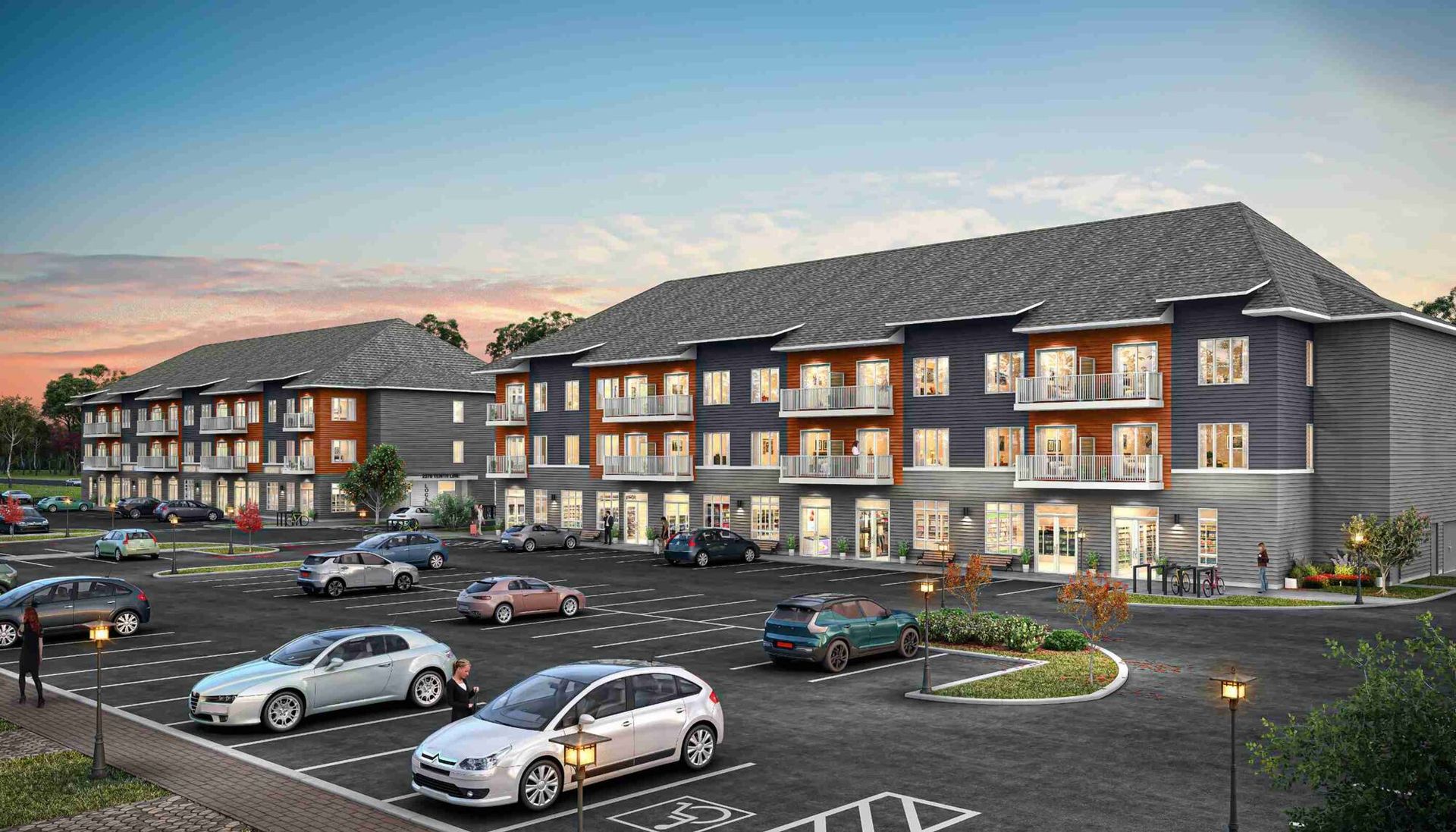 Complexe d'appartements moderne au crépuscule, avec balcons éclairés et voitures garées sur le parking