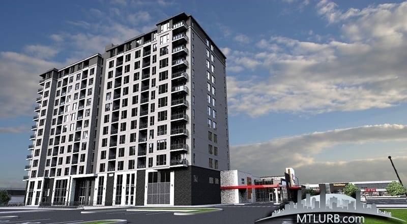 Immeuble d'appartements moderne de grande hauteur avec façade grise et blanche sur fond de ciel bleu nuageux.