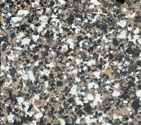 A close up of a gray and white marble floor with a hole in the middle.