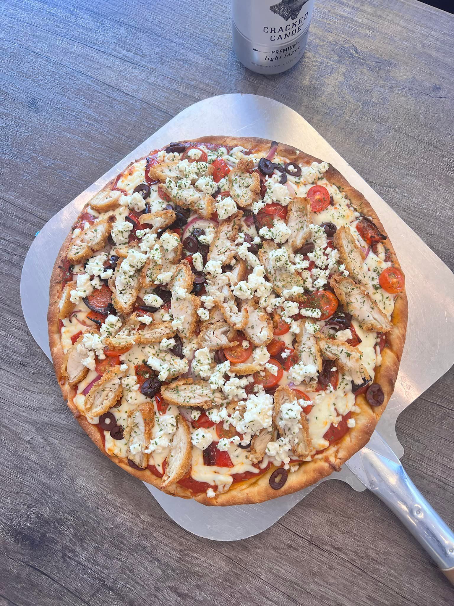 A pizza is sitting on top of a pizza pan on a table.
