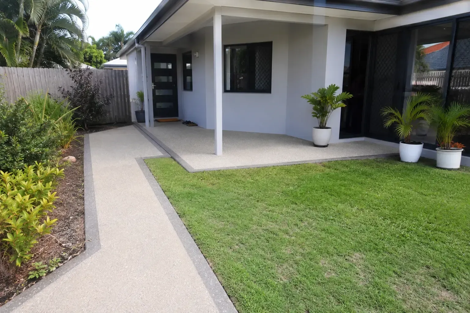 Exposed aggregate path and patio with coloured edging. Townsville yard.