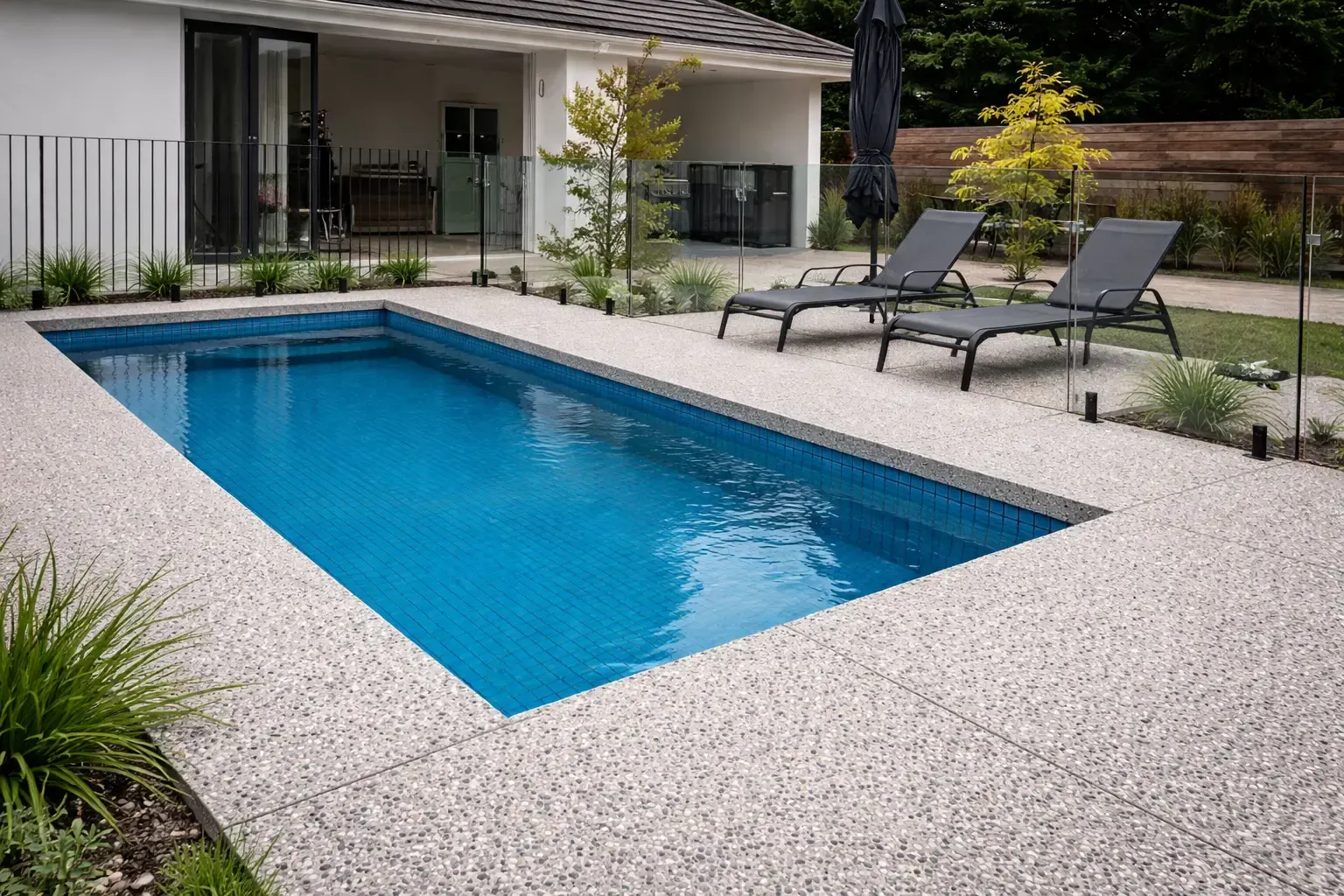 Rectangular pool with exposed aggregate concrete pool surround in Kelso, Townsville