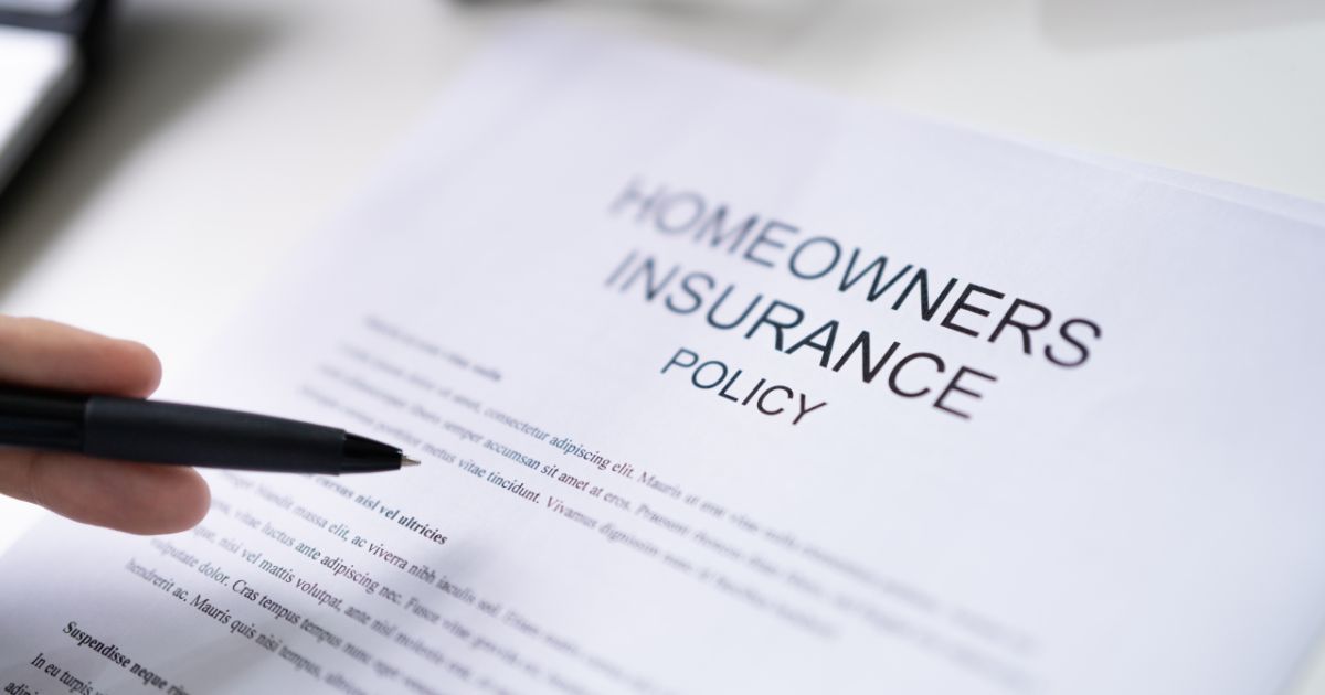 Person pointing a pen at a homeowners insurance policy while reviewing a claim in Dallas Fort Worth.