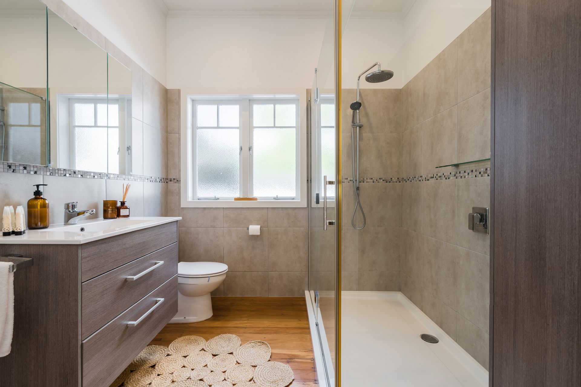 A bathroom with a toilet , sink , and walk in shower. A bathroom with a toilet , sink , and walk in shower.