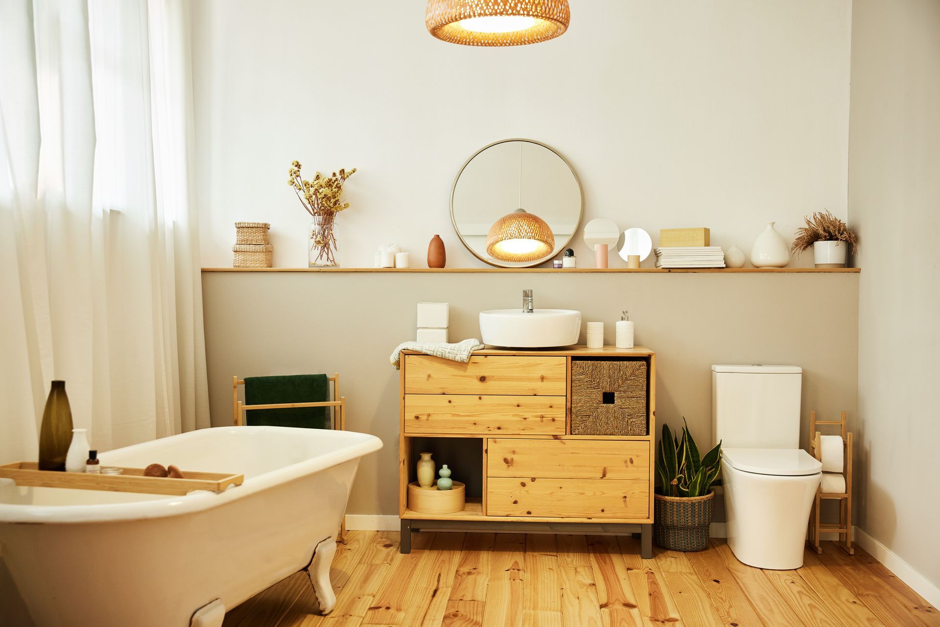 A bathroom with a bathtub , toilet , sink and mirror.