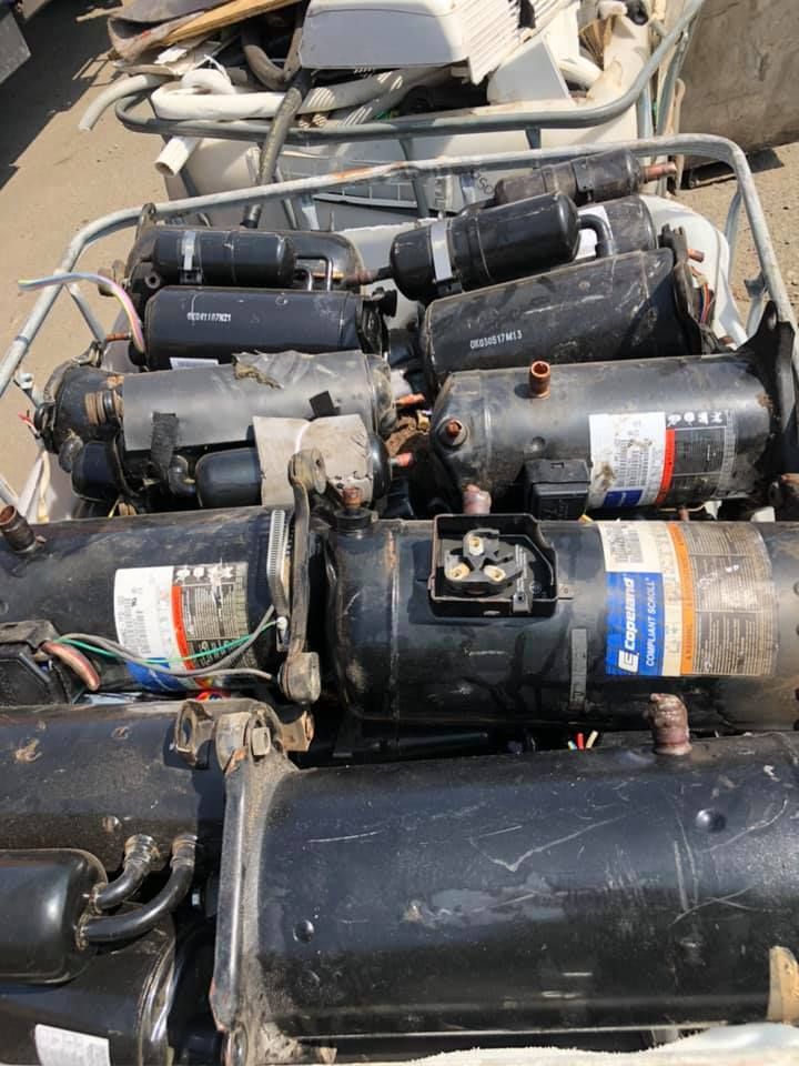 A Bin Overflowing With Discarded Black Air Conditioner Compressors — H&H Metal Recycling in Pelican Waters, QLD