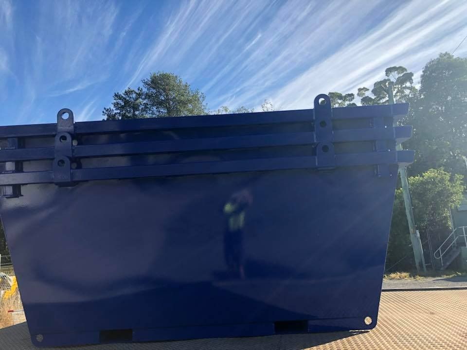 A Blue Dumpster Is Sitting on The Ground in Front of A Blue Sky — H & H Metal Recycling In Cooroy, QLD