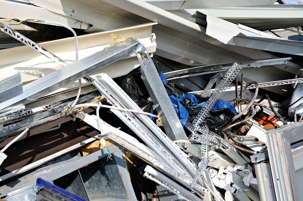 A Pile of Scrap Metal Is Sitting on Top of Each Other — H & H Metal Recycling In Cooroy, QLD