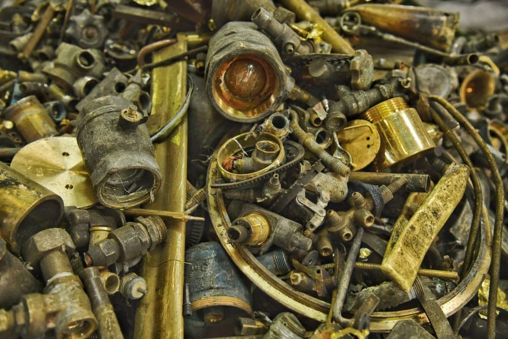 A Pile of Brass Scrap Metal Is Sitting on A Table — H & H Metal Recycling In Kunda Park, QLD