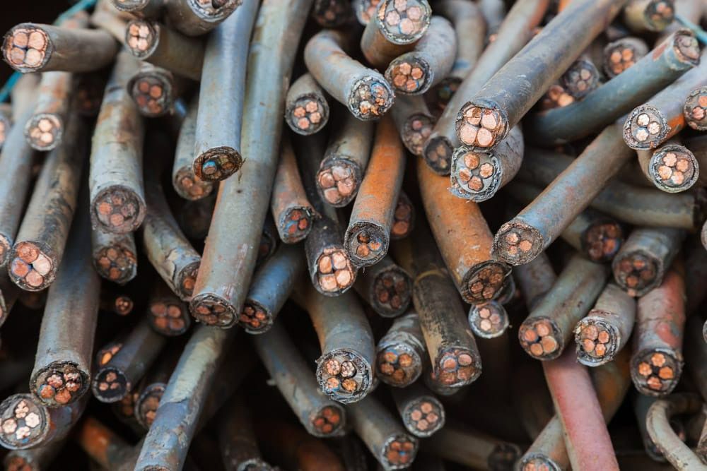A Pile of Copper Wire Is Sitting on Top of Each Other on A Table — H & H Metal Recycling In Caboolture, QLD