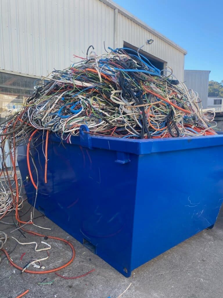 A Blue Dumpster Filled with A Pile of Wires — H & H Metal Recycling In Nambour, QLD