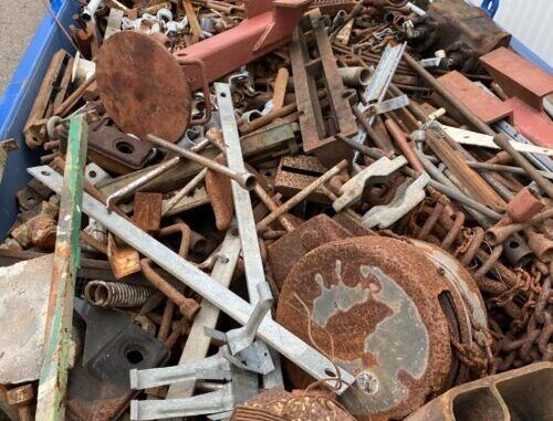 A Pile of Rusty Metal Is Sitting in A Blue Bin — H & H Metal Recycling In Cooroy, QLD