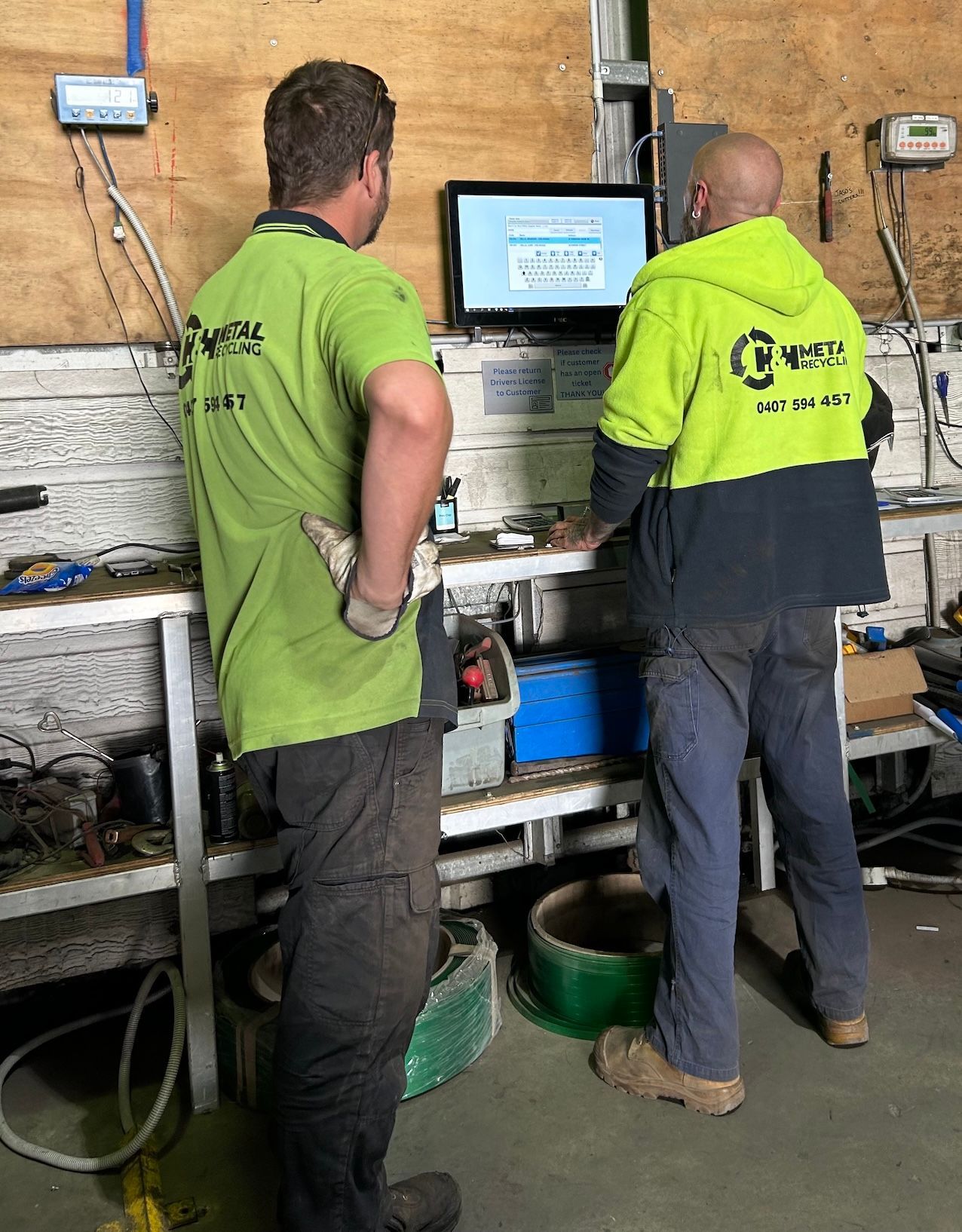 Workmen Looking At Computer Screen — H & H Metal Recycling In Kunda Park, QLD